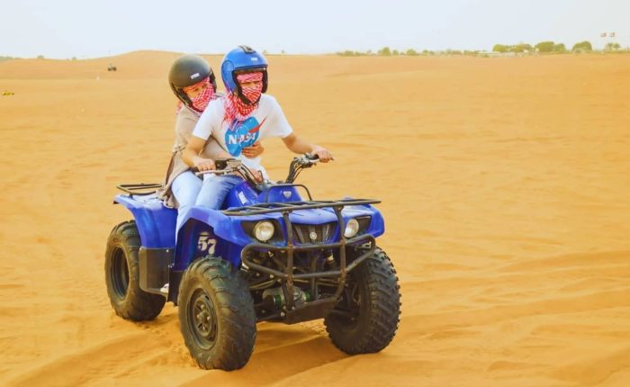 Desert Safari Dubai with Quad Bike, Camels Ride & BBQ Dinner quad biking in desert