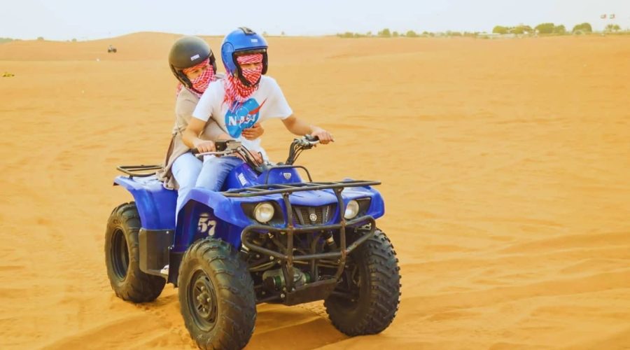Desert Safari Dubai with Quad Bike, Camels Ride & BBQ Dinner quad biking in desert